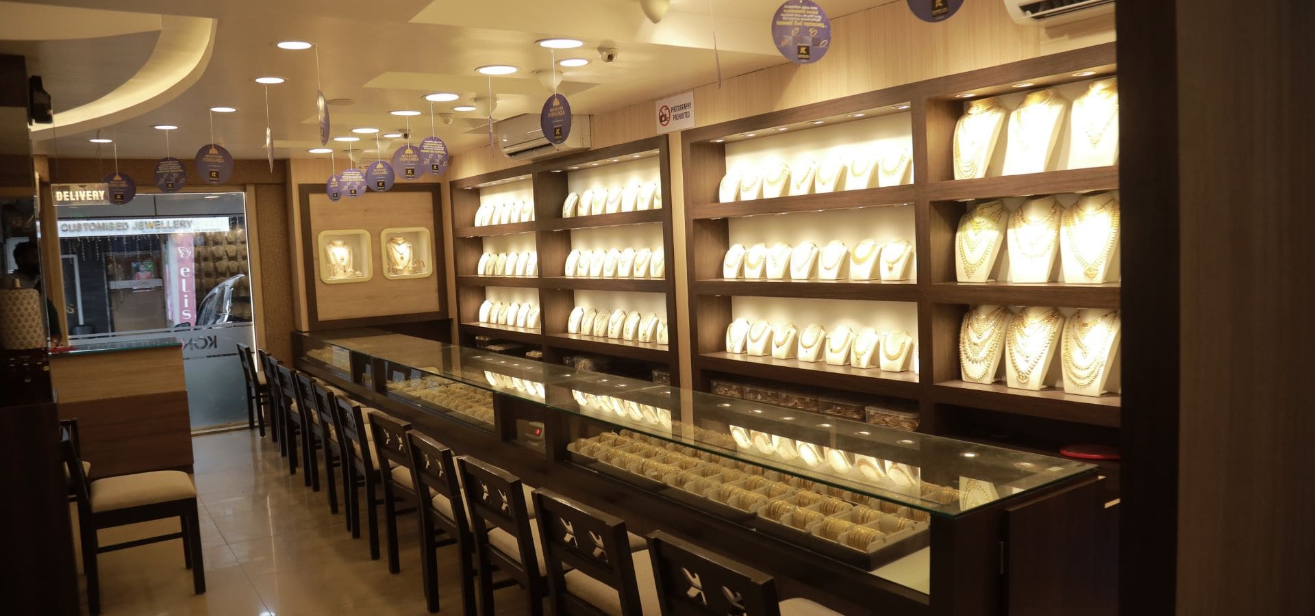 Inside JJ Jewellers showroom — gold display counters at JJ Mansion, Thrissur